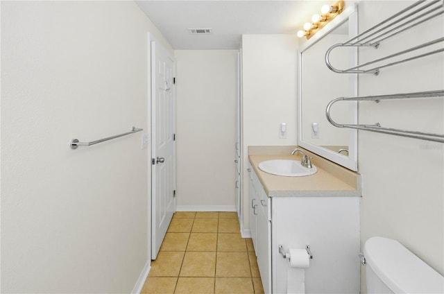 bathroom with visible vents, baseboards, toilet, tile patterned floors, and vanity