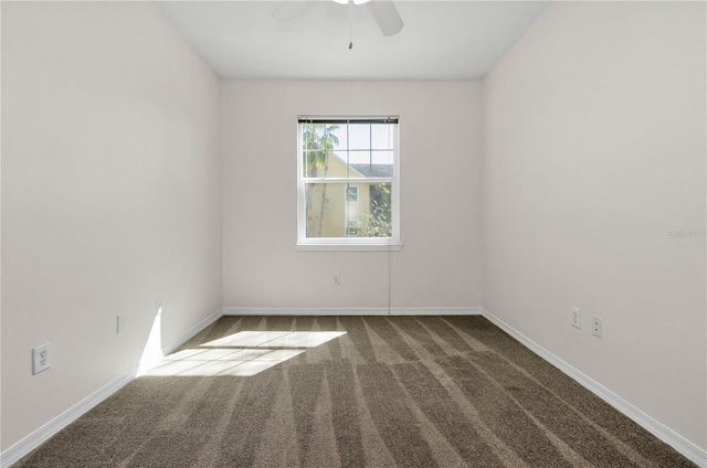 empty room with baseboards, ceiling fan, and carpet floors