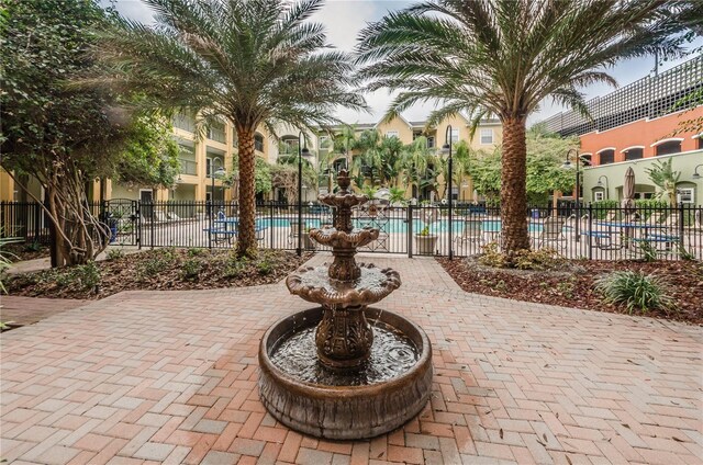 view of patio / terrace with a community pool and fence