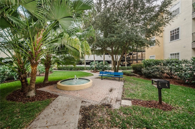 view of property's community with a lawn