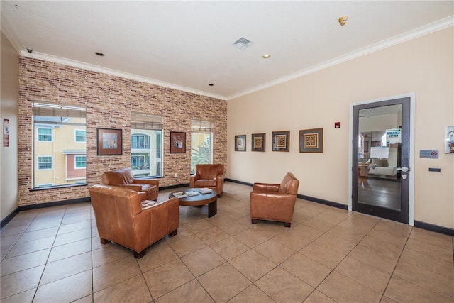 living area featuring crown molding, baseboards, light tile patterned flooring, brick wall, and visible vents