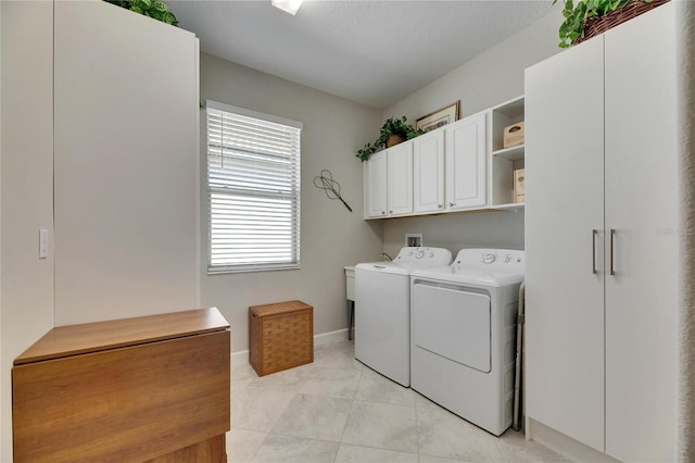 laundry area with cabinet space, baseboards, and washing machine and clothes dryer