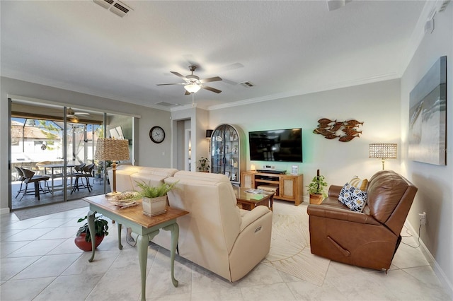 living area featuring visible vents, baseboards, crown molding, and a ceiling fan