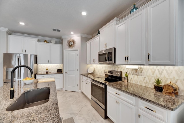 kitchen with visible vents, ornamental molding, appliances with stainless steel finishes, and a sink