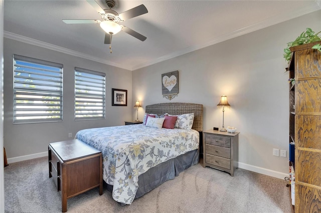 bedroom featuring ceiling fan, crown molding, baseboards, and light carpet