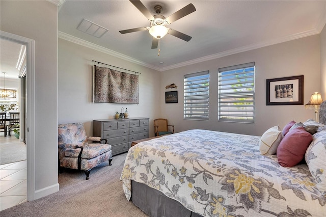 bedroom featuring visible vents, ornamental molding, light carpet, light tile patterned flooring, and a ceiling fan