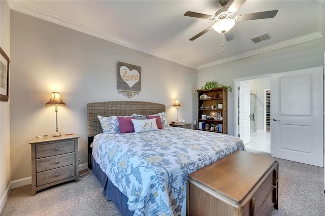 carpeted bedroom with visible vents, baseboards, ornamental molding, and a ceiling fan