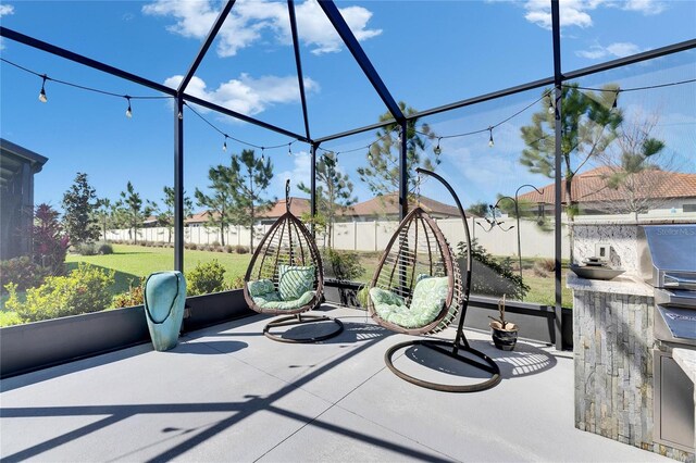 exterior space featuring glass enclosure and fence