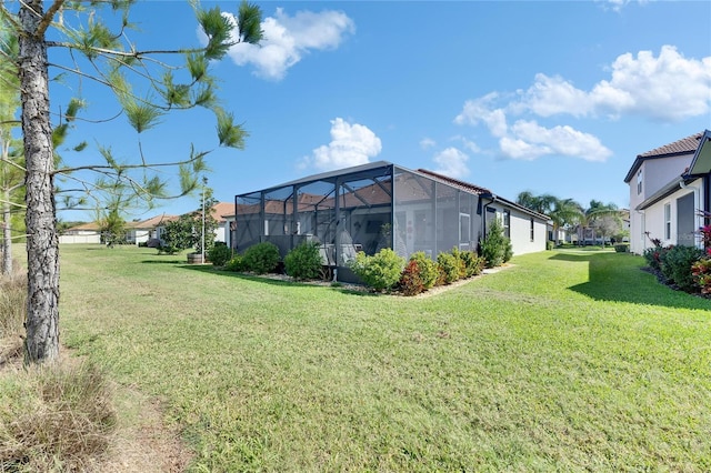 view of yard with a lanai and a residential view