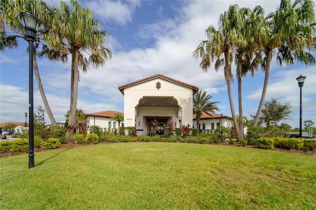 exterior space featuring a front lawn and stucco siding