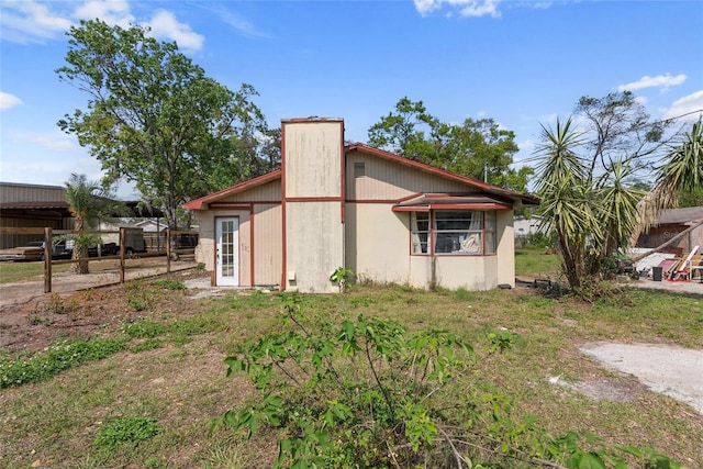 view of side of home with a chimney