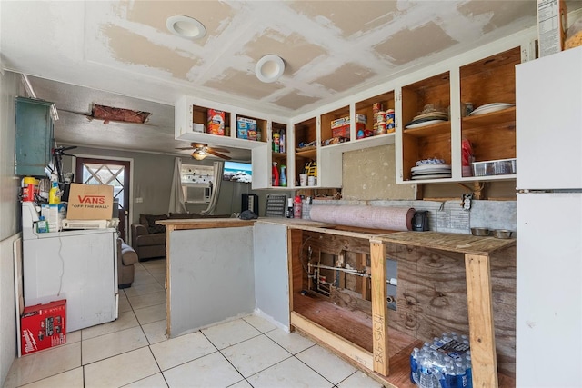 kitchen with light tile patterned flooring, freestanding refrigerator, a ceiling fan, and open shelves