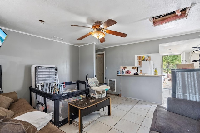 living room with ornamental molding, heating unit, a textured ceiling, light tile patterned flooring, and ceiling fan