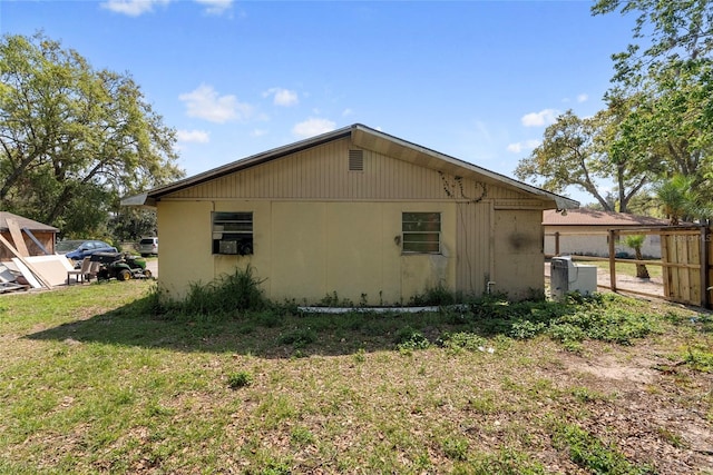 view of side of property featuring a yard and fence