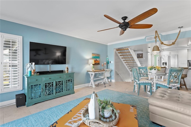 living room with stairs, crown molding, and tile patterned floors