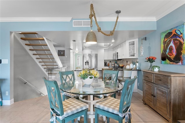 dining area featuring visible vents, crown molding, baseboards, stairs, and light tile patterned flooring