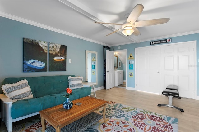 living area with ceiling fan, light wood-style flooring, baseboards, and ornamental molding