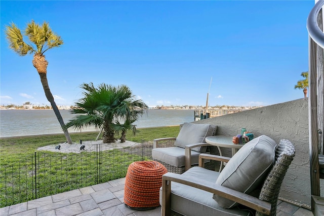 view of patio / terrace with a balcony and a water view