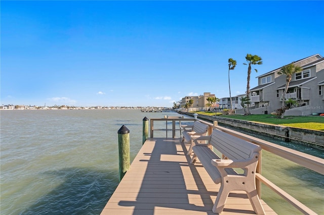 view of dock featuring a residential view and a water view