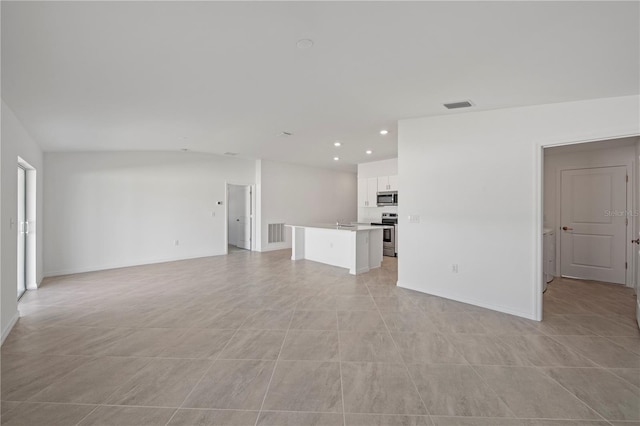 unfurnished living room featuring visible vents, recessed lighting, and baseboards