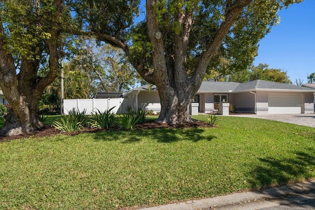 view of front of home featuring fence, an attached garage, stucco siding, a front lawn, and concrete driveway