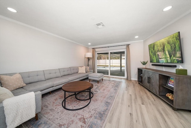 living area with recessed lighting, visible vents, wood finished floors, and ornamental molding