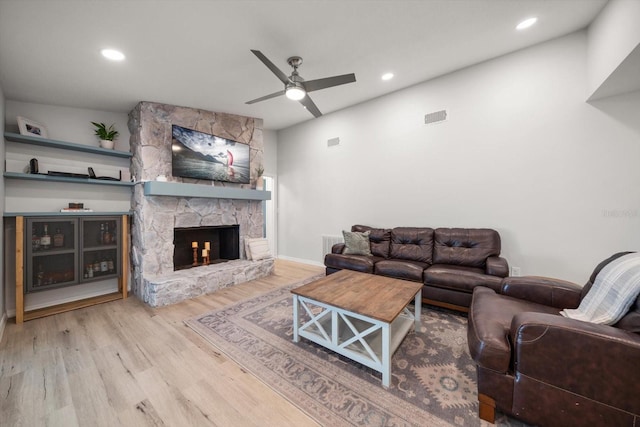 living room featuring visible vents, ceiling fan, recessed lighting, a fireplace, and wood finished floors