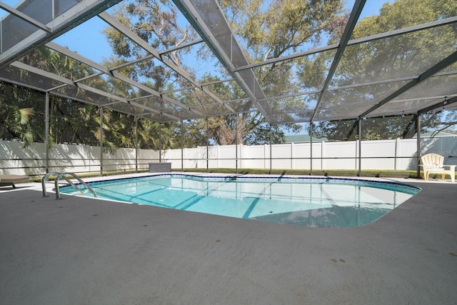 view of pool featuring a patio area, a fenced in pool, glass enclosure, and fence