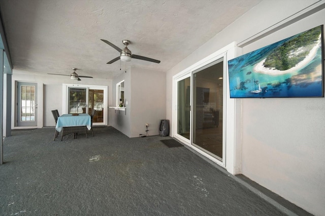 unfurnished sunroom with a ceiling fan