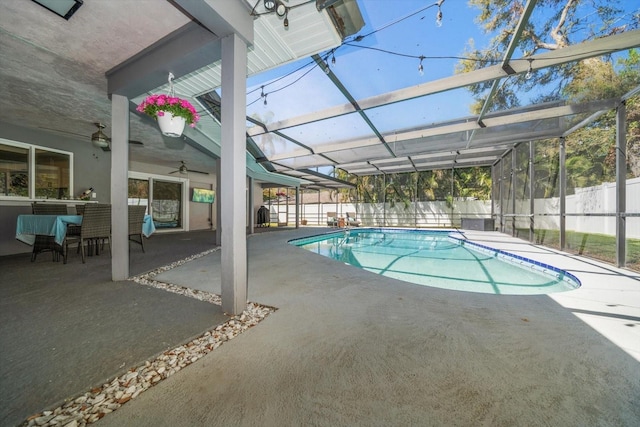 view of pool with glass enclosure, a patio, a fenced in pool, and a fenced backyard