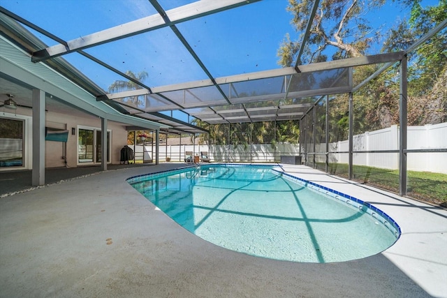 view of pool with a patio, a fenced backyard, and a lanai