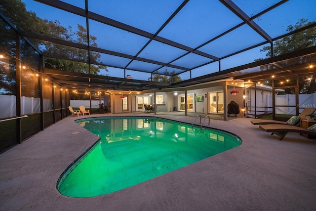 view of pool featuring glass enclosure, a patio, a fenced backyard, and a fenced in pool