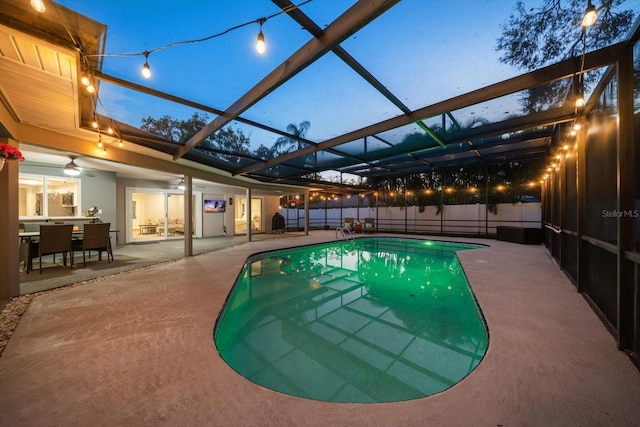 view of swimming pool featuring a lanai, a fenced in pool, a patio, and fence