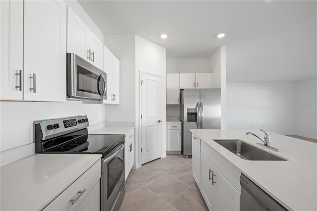 kitchen with light countertops, recessed lighting, white cabinets, stainless steel appliances, and a sink