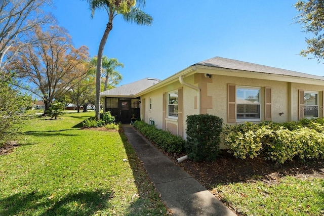 view of property exterior featuring a lawn and stucco siding