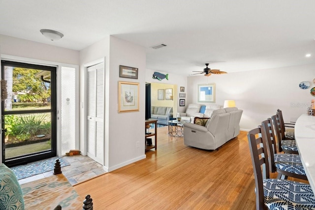 entrance foyer featuring visible vents, plenty of natural light, light wood-style floors, and baseboards