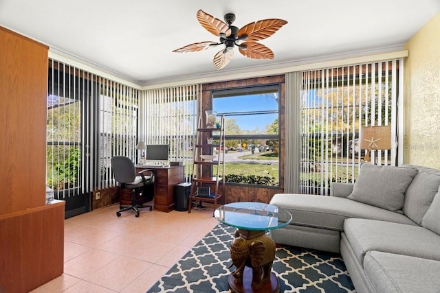 home office featuring a wealth of natural light, a textured wall, a ceiling fan, and tile patterned flooring