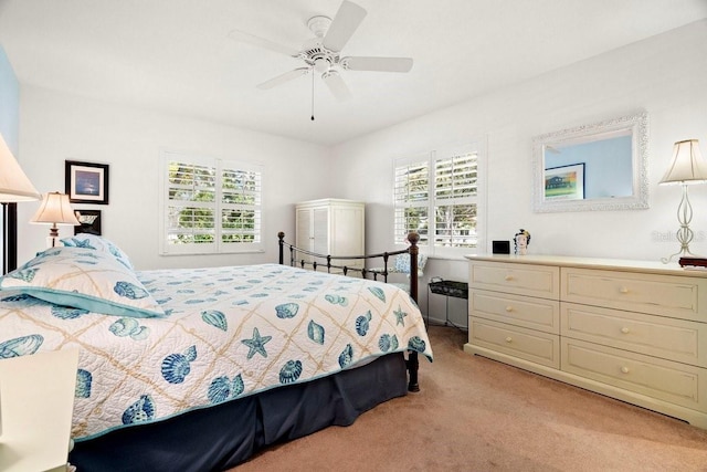 bedroom with multiple windows, light carpet, and ceiling fan