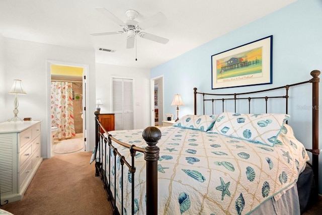 carpeted bedroom featuring ceiling fan, visible vents, a closet, and connected bathroom