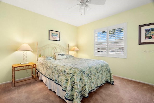 carpeted bedroom with a ceiling fan and baseboards