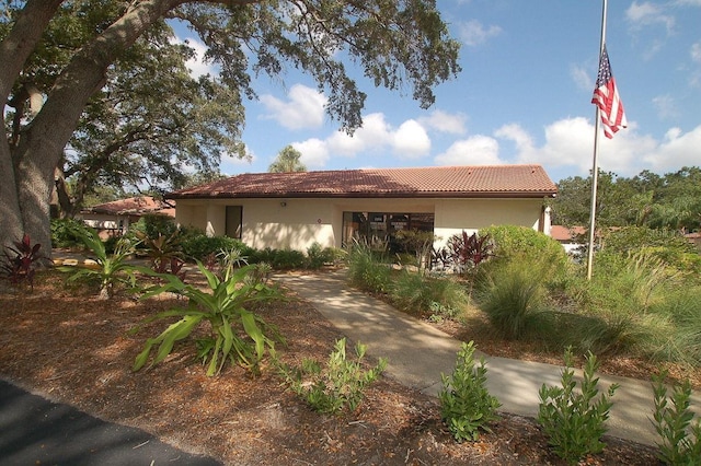 view of front of house featuring a tile roof and stucco siding