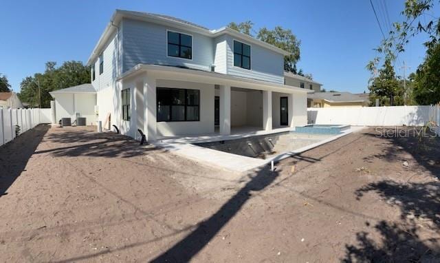 rear view of house with central air condition unit, a fenced backyard, a patio, a fenced in pool, and stucco siding