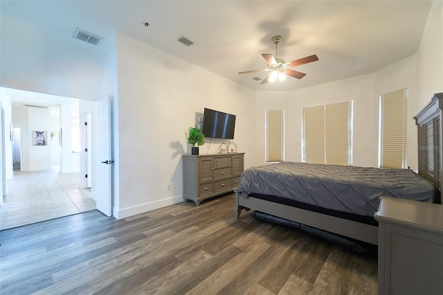 bedroom featuring visible vents, baseboards, and wood finished floors