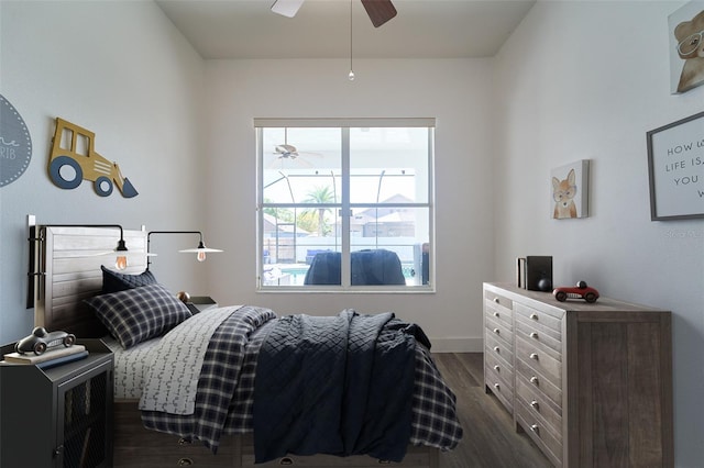 bedroom with baseboards, dark wood-type flooring, and ceiling fan