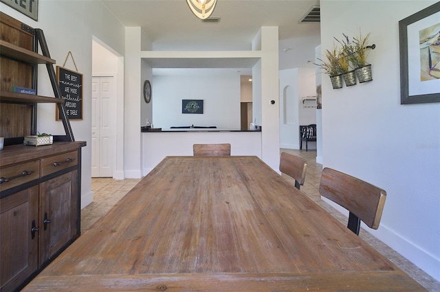 dining space featuring light tile patterned flooring and visible vents