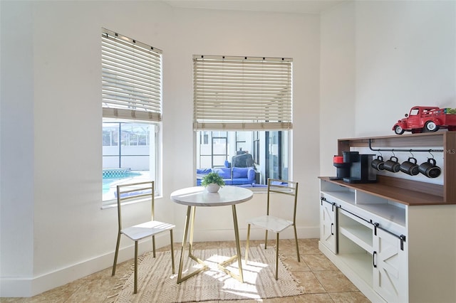 dining room featuring light tile patterned floors and baseboards