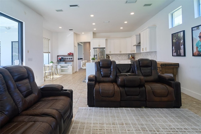 home theater room featuring recessed lighting, visible vents, baseboards, and light tile patterned floors