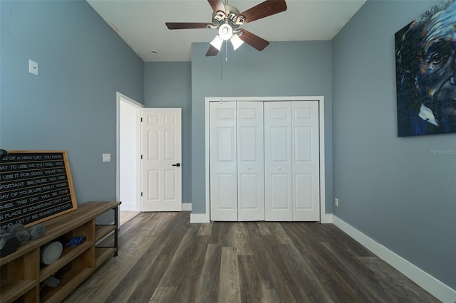 bedroom featuring a closet, baseboards, dark wood-style floors, and a ceiling fan