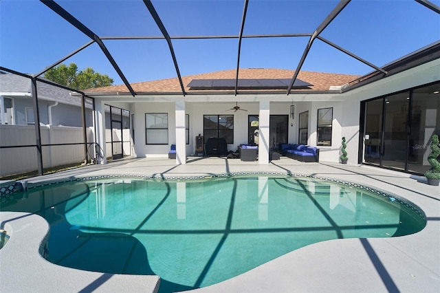 pool featuring glass enclosure, a patio, a ceiling fan, and fence