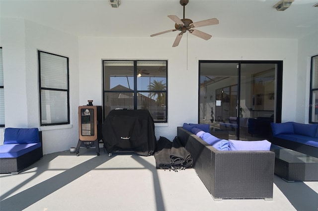 view of patio / terrace with an outdoor living space, area for grilling, and a ceiling fan